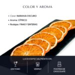 Rodajas de naranja deshidratada sobre pizarra: color naranja oscuro y aroma cítrico; lucen en gin tonic, vermut y postres de chocolate