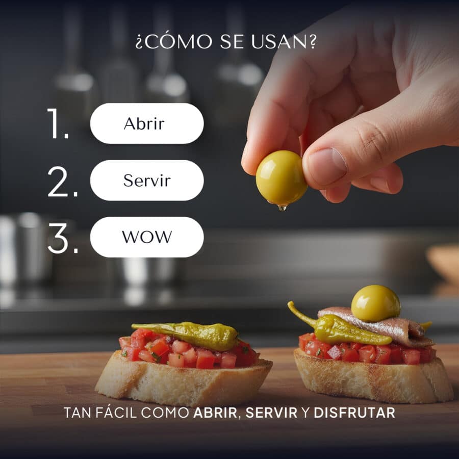 Mano colocando una perla de oliva verde Pearls sobre una tosta de tomate y anchoa