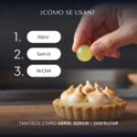 Mano colocando con los dedos una Pearl de Limoncello sobre una tartaleta de limón con merengue